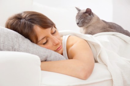 cat sleeping on woman