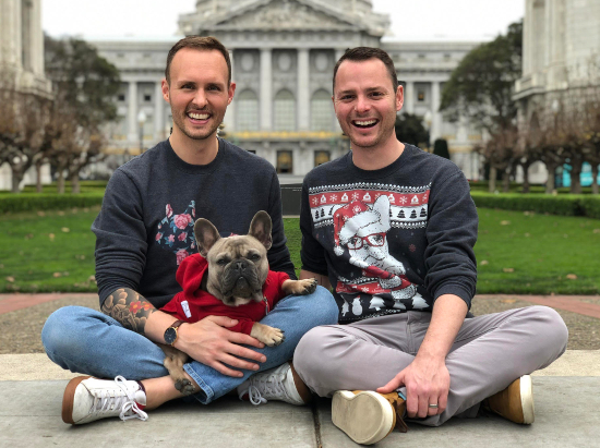 photo of two men with french bulldog