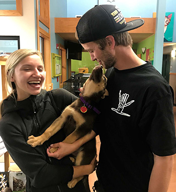 A couple is thrilled with the puppy they adopted through Okandogs.
