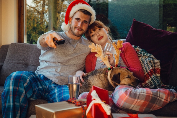holiday couple and dog watching TV