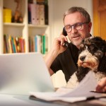 Man budgeting with dog