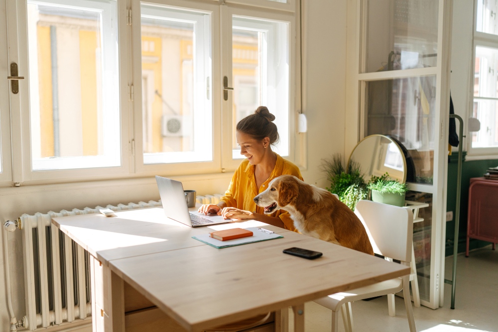 woman and dog on laptop